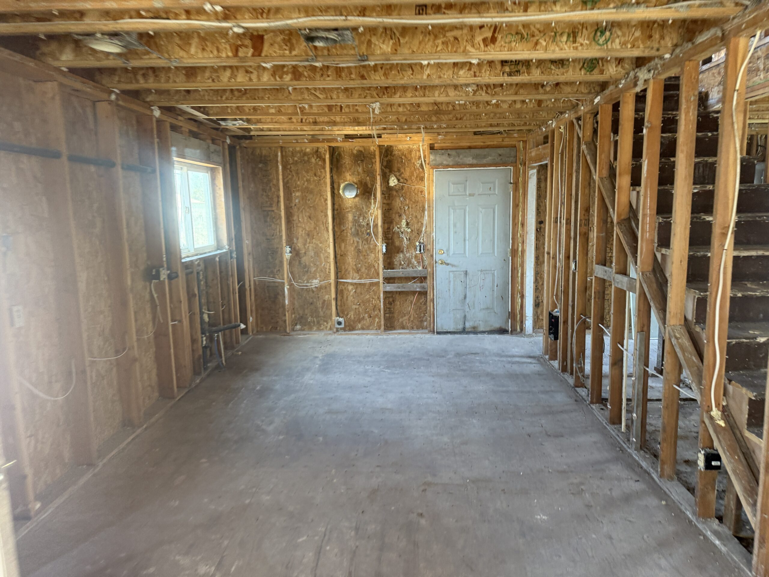 Interior stripped back to studs and bare concrete ahead of further work