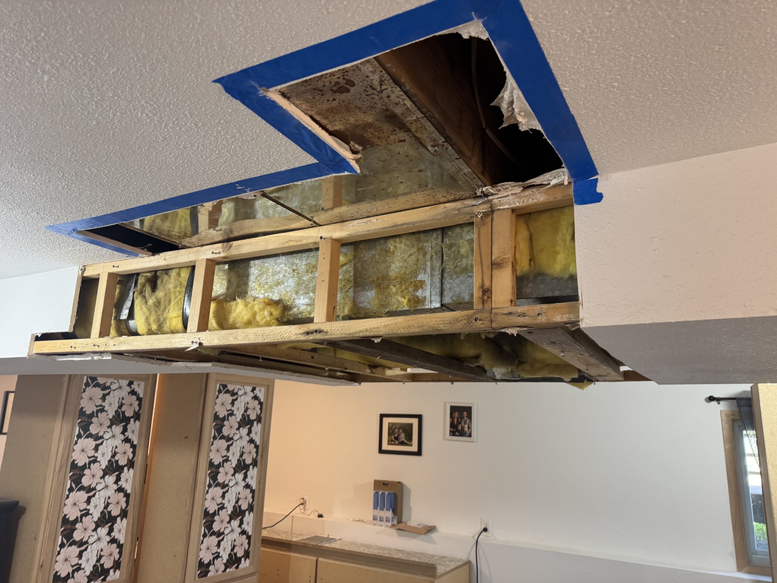 Kitchen ceiling opened and contained after water damage