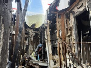 Structure gutted by fire with charred framing exposed and the roof burned through